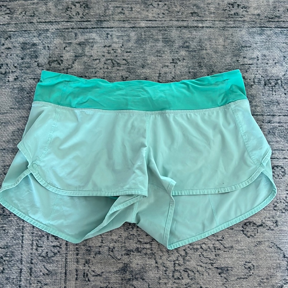 size 6 lululemon running shorts with built in briefs and zip back pocket
